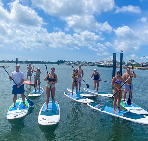 People standing on paddleboards